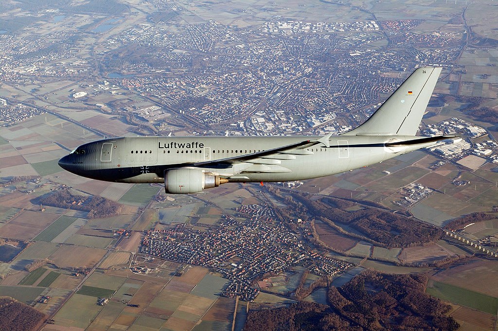 Luftwaffe Airbus A310 MRTT flying above fields and towns.