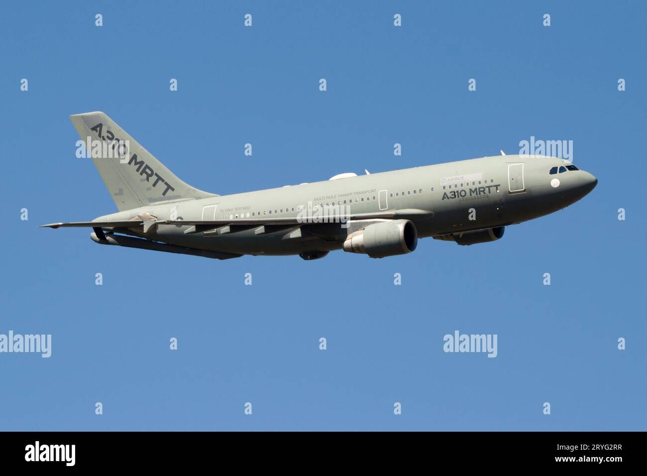 Gray A310 MRTT demonstrator flying against a blue sky.
