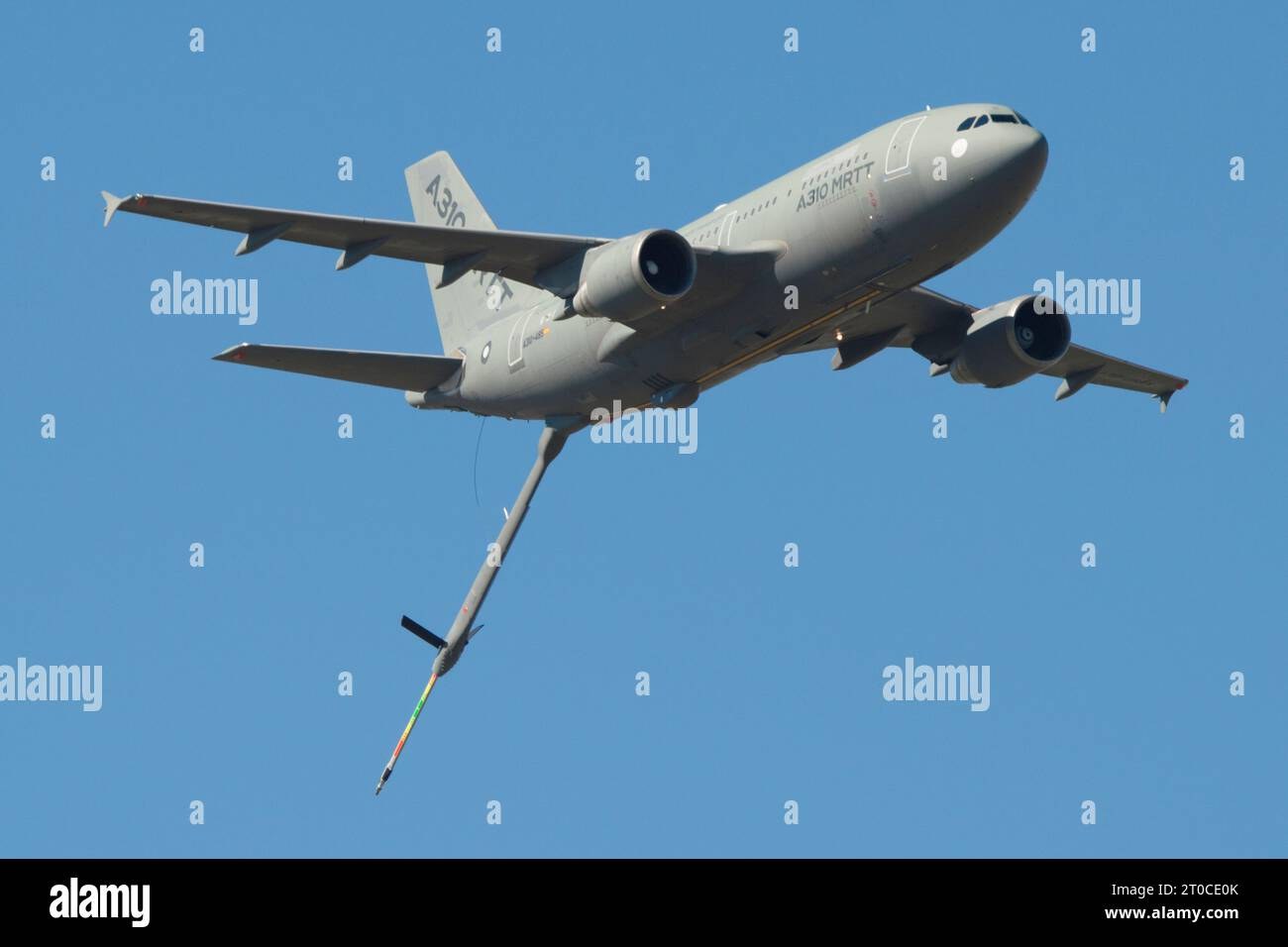 Gray A310 MRTT in flight with refueling boom deployed below the fuselage.