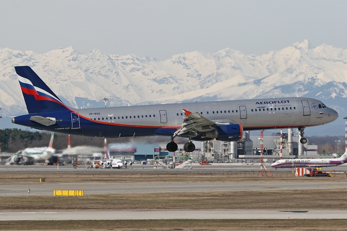 Aeroflot Airbus A321 landing with mountains behind the runway.