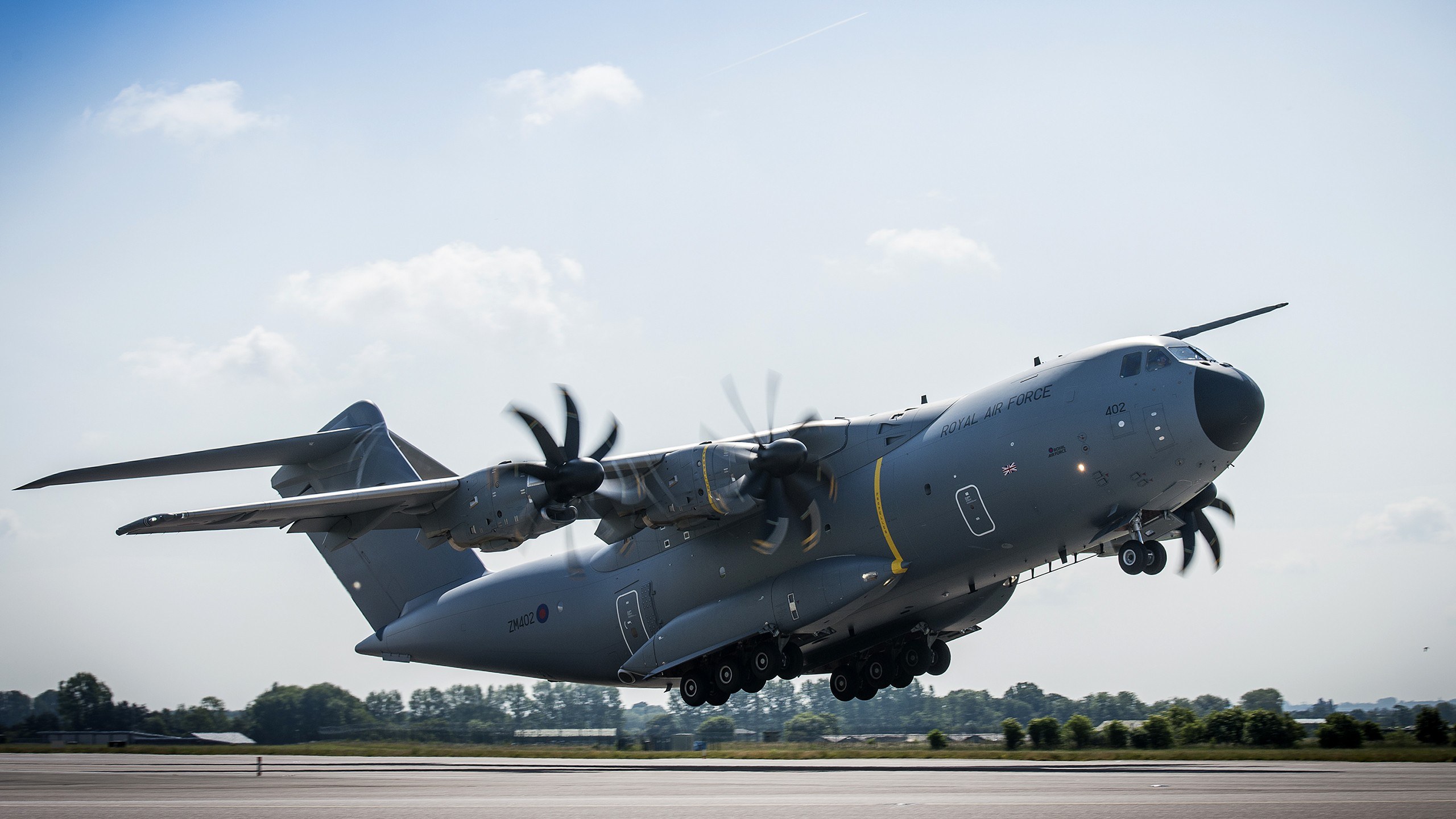 Royal Air Force Airbus A400M Atlas ZM402 climbing with landing gear extended.