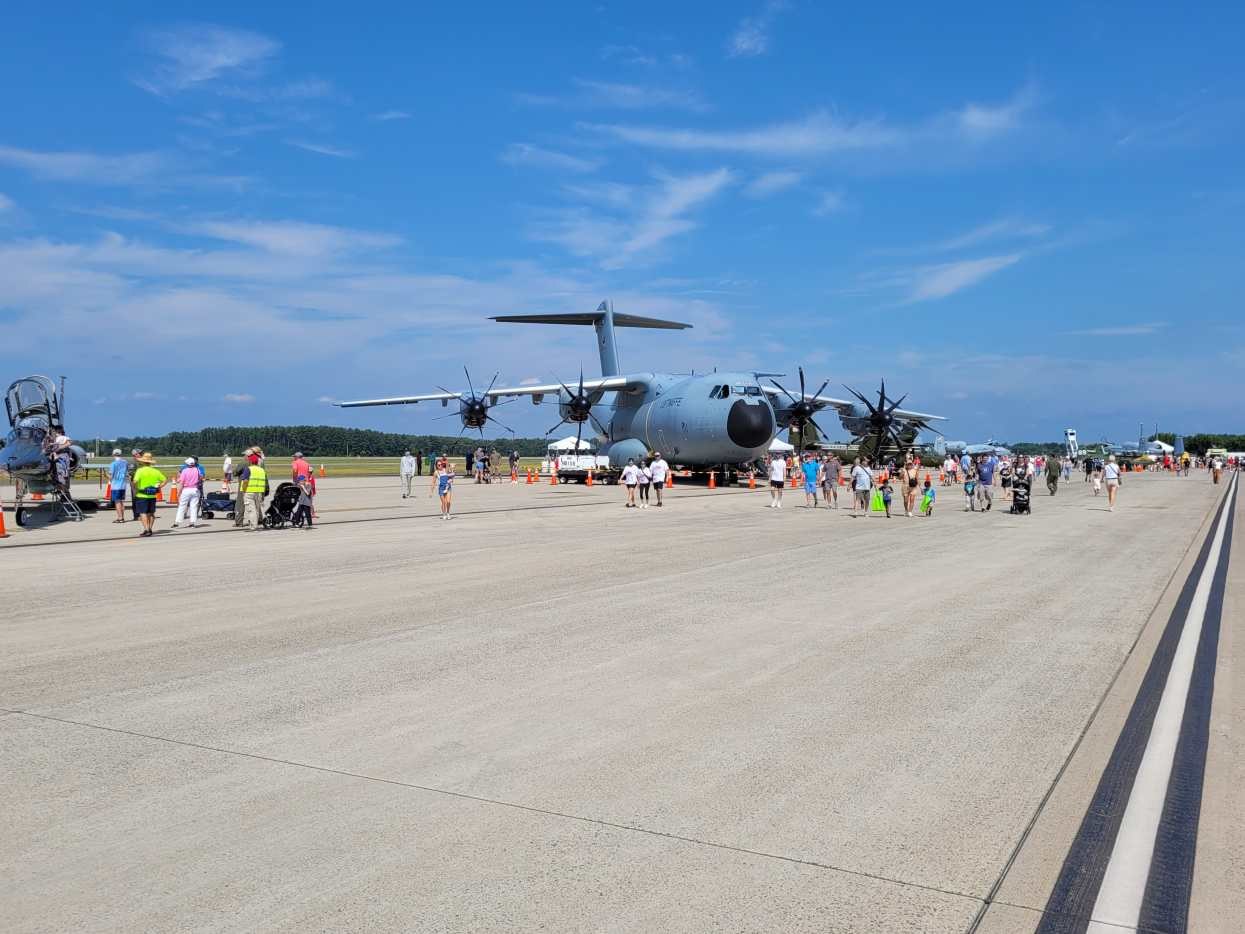 Airbus A400M Atlas parked on a wide ramp with visitors walking around it.