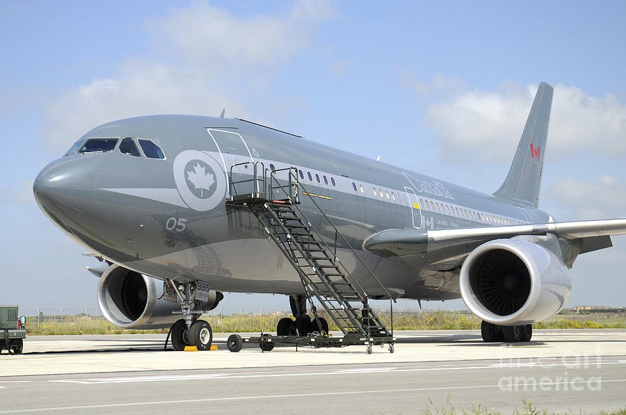 Gray Canadian CC-150 Polaris parked with boarding stairs at the forward door.