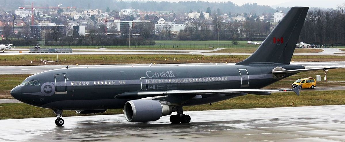 Dark gray Canada CC-150 Polaris 01 taxiing on wet pavement.
