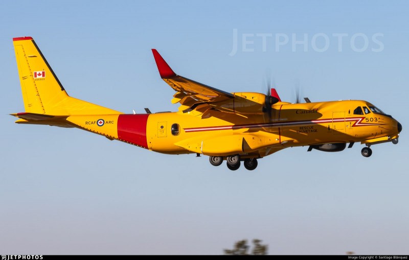 Yellow RCAF CC-295W Kingfisher 503 in flight with landing gear extended.