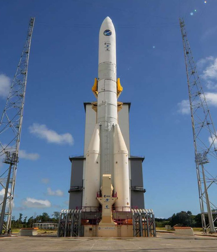 Ariane 6 launch vehicle on its pad between service towers, showing the newer European launch system connected to Airbus space work.