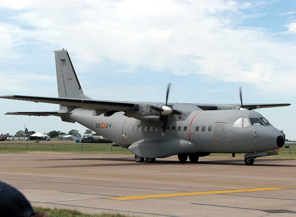 CASA CN-235 military transport aircraft on an airport apron, showing the twin-turboprop tactical transport inherited through the CASA and Airbus military-aircraft line.