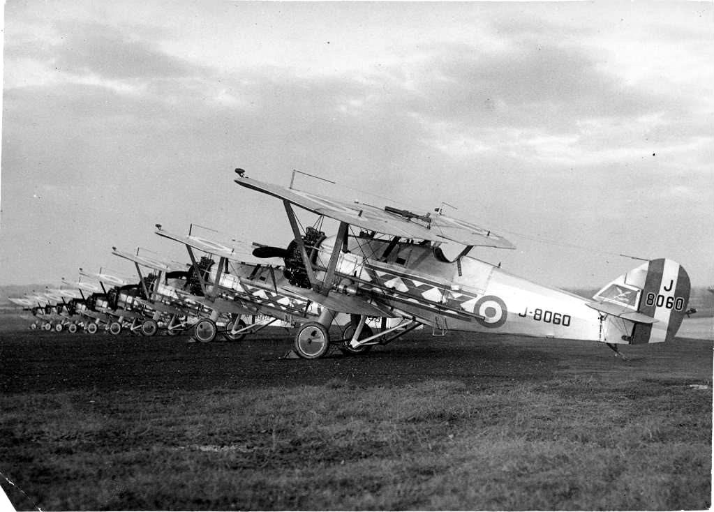 Black-and-white lineup of Siskin biplanes with J-8060 in front.