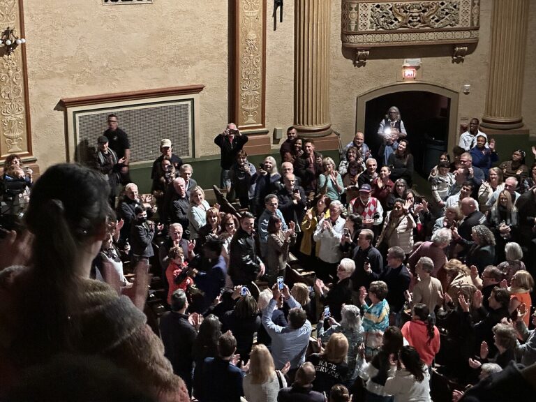 Jon Batiste playing melodica in the aisles during improvised performance at Count Basie Theatre