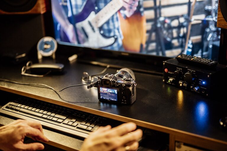 Recording session takes place with camera and computer in music studio