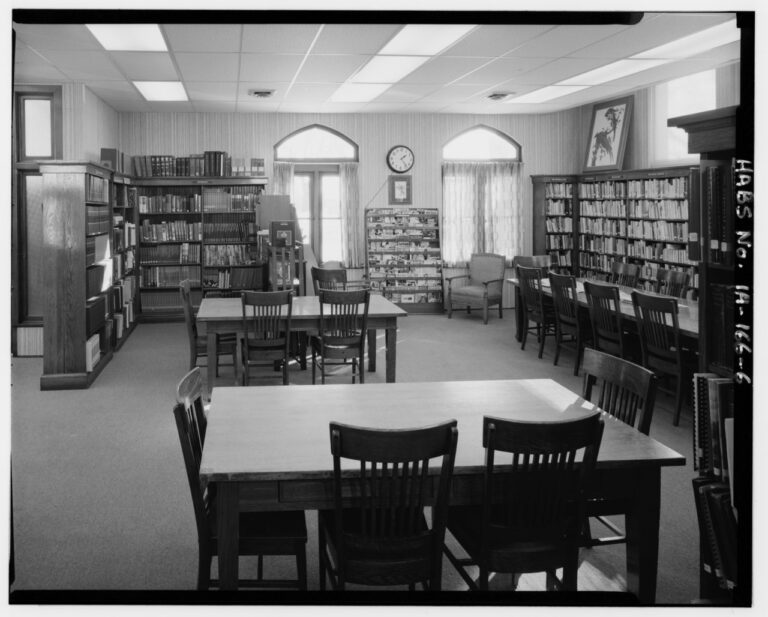 Interior from northwest corner facing south bookshelves newspaper rack casement windows and reading tables