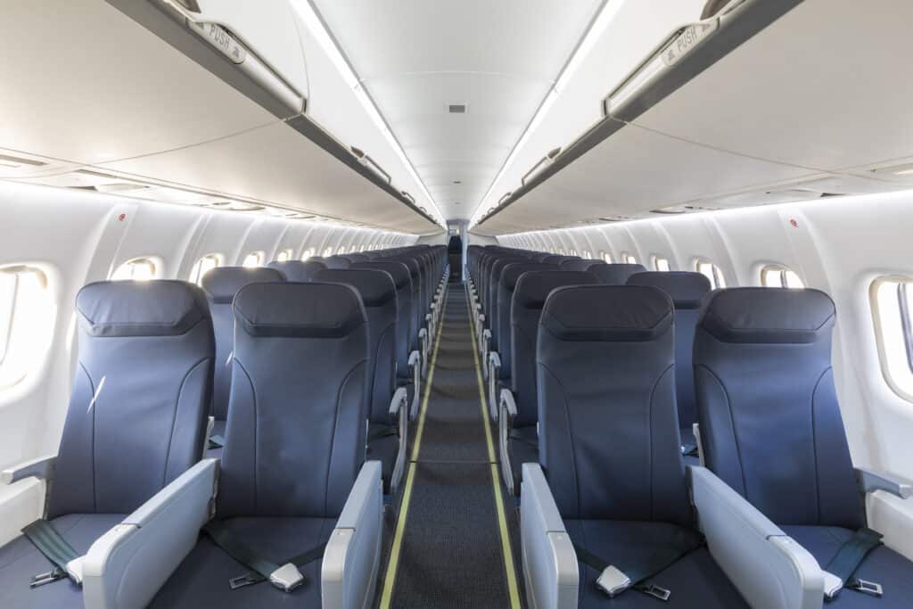 ATR 72-600 passenger cabin with rows of seats and overhead bins.