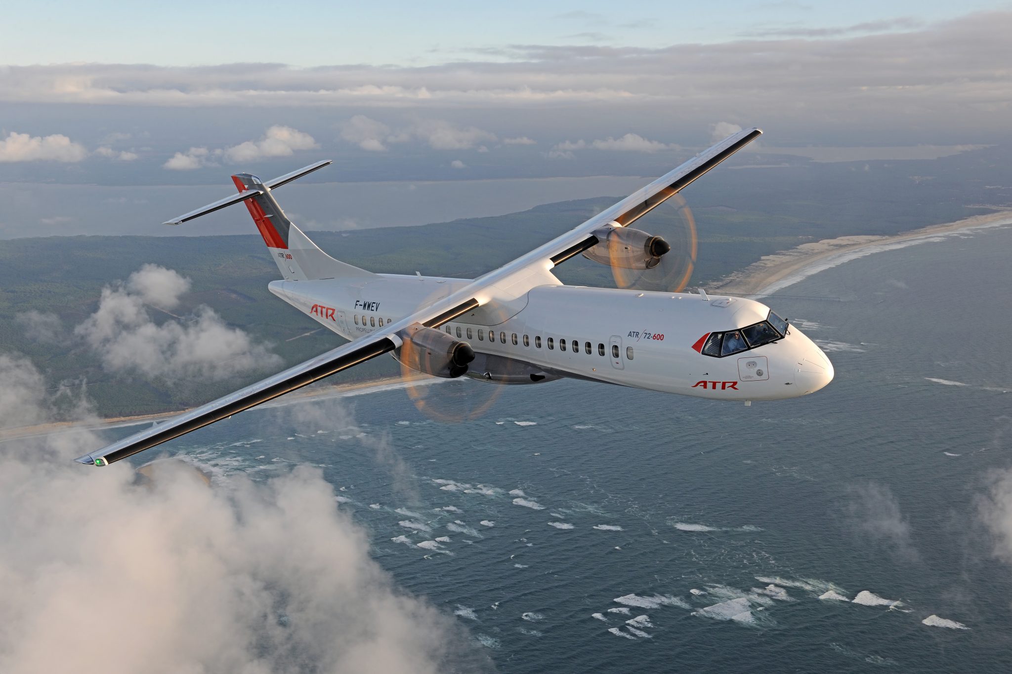 ATR 72-600 turboprop aircraft flying above clouds.
