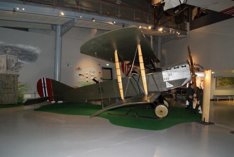 Avro 504 biplane displayed indoors in a museum gallery.