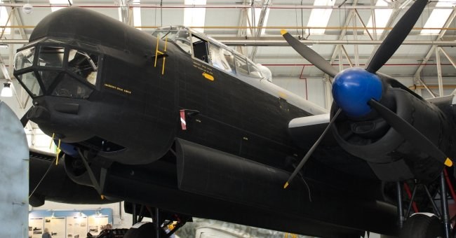 Close indoor view of an Avro Lincoln nose, cockpit glazing, and near-side engine.