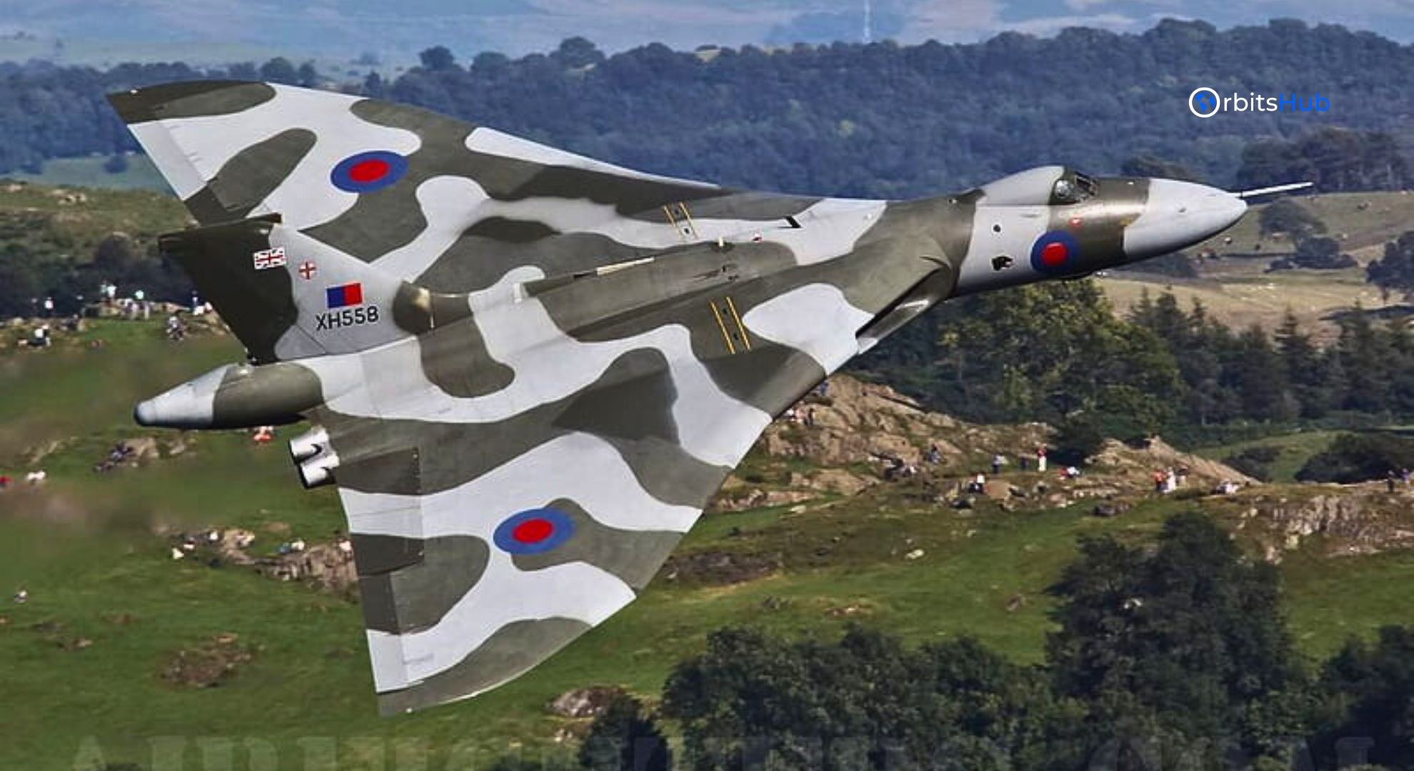 Avro Vulcan XH558 banking over green hills with delta wing visible.