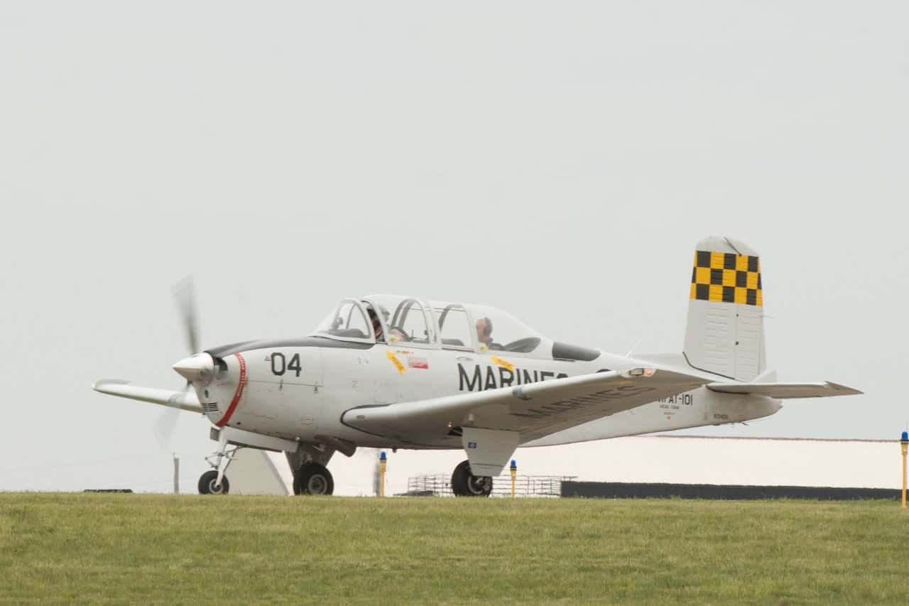 White Marine-marked Beechcraft T-34 Mentor 04 taxiing with propeller blurred.