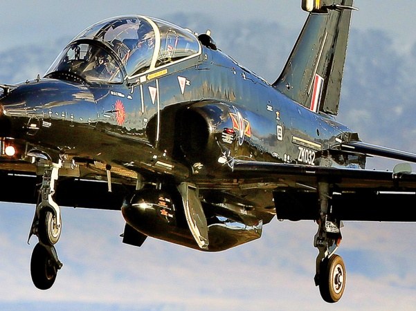 Black Beechcraft Texan T1 ZM329 flying with landing gear down.
