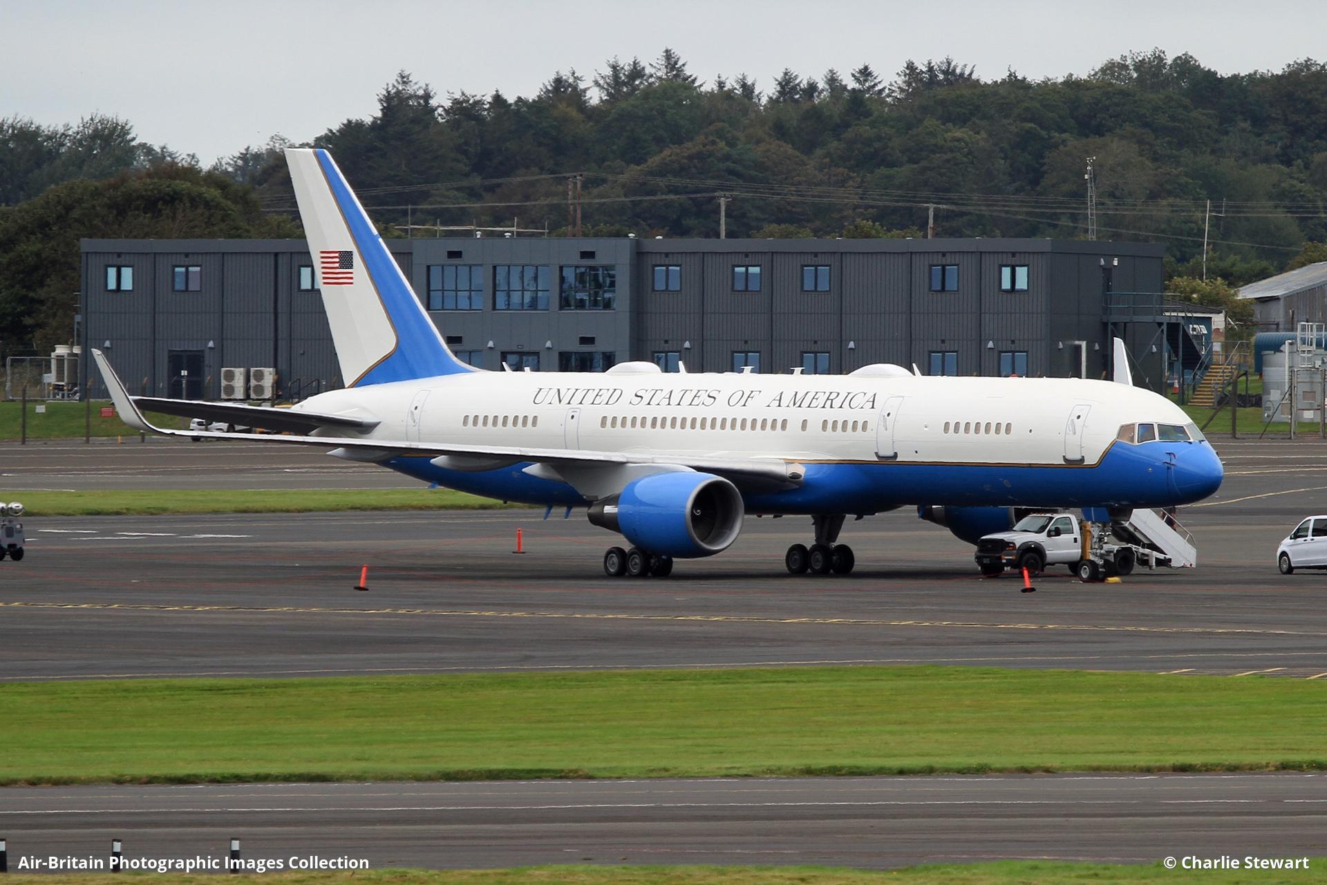 Blue-and-white Boeing C-32 parked on an airport ramp with stairs at the forward door.