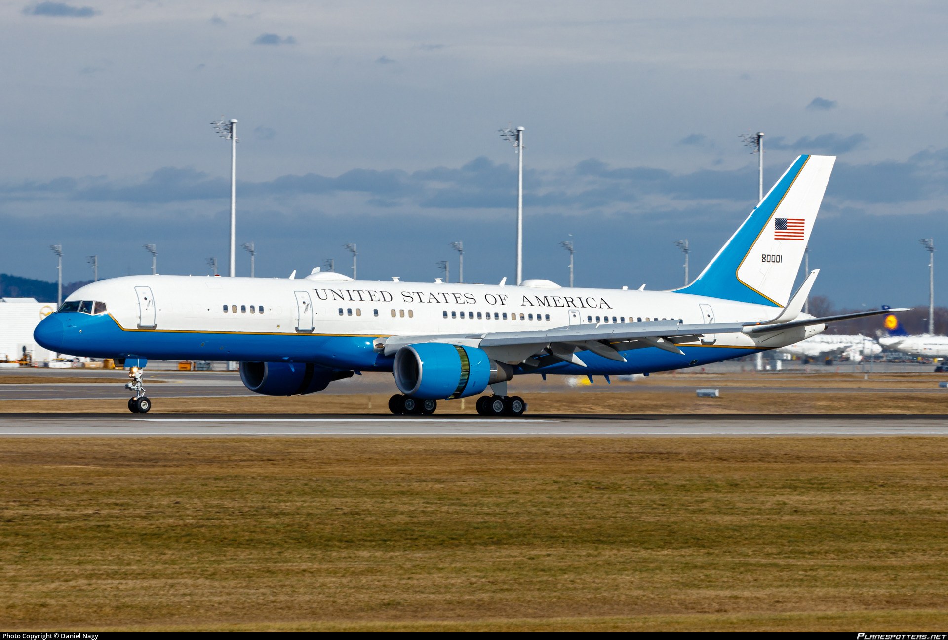 Blue-and-white Boeing C-32 80001 taxiing on a runway.