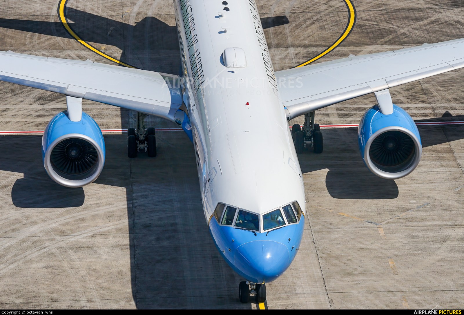 Overhead view of a blue-and-white Boeing C-32 showing nose, wings, and two engines.