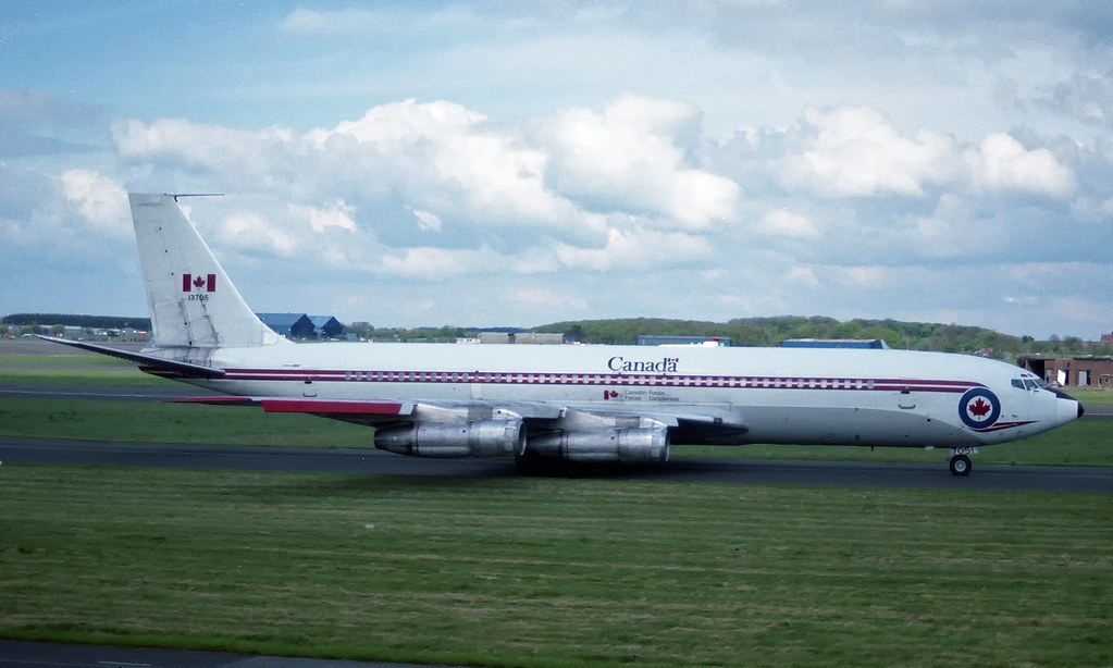 Canada-marked Boeing CC-137 13705 taxiing beside a grassy runway.