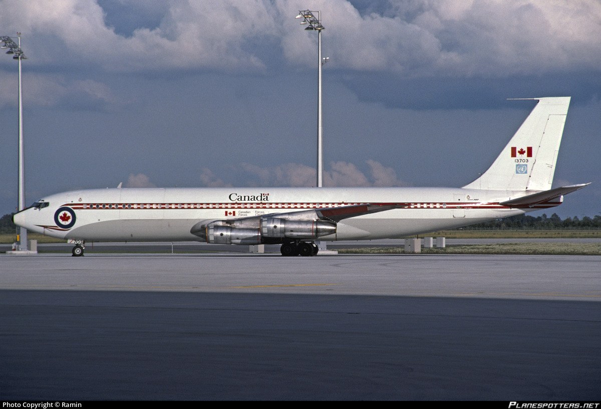 Canada Boeing CC-137 13703 parked on a ramp beneath dark clouds.