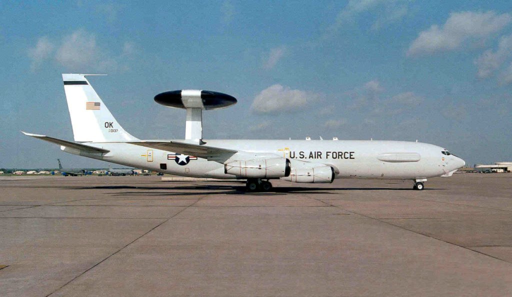 Wider side view of U.S. Air Force Boeing E-3 Sentry OK 0137 parked on an apron.