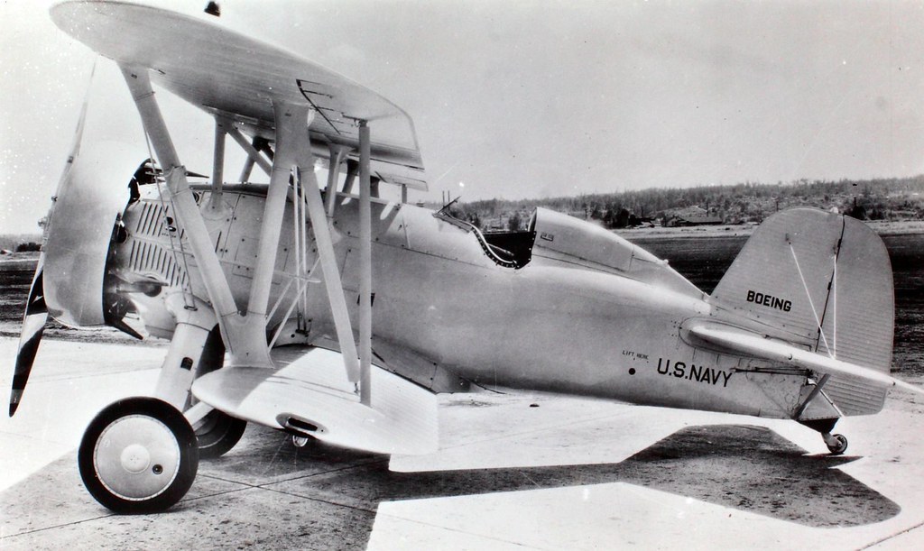 U.S. Navy Boeing F4B biplane parked on pavement in a side view.