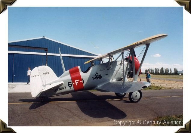 Restored Boeing F4B-4 marked 6-F-1 parked beside a blue hangar.