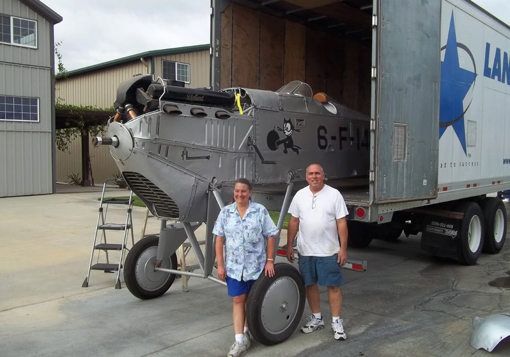 Boeing FB biplane marked 6-F-1 partly unloaded from a trailer.