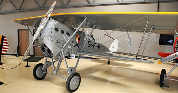 Boeing FB biplane marked 6-F-11 displayed indoors.