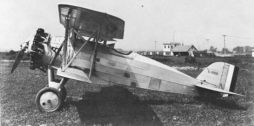 Boeing FB biplane A-6896 parked on grass in a side view.