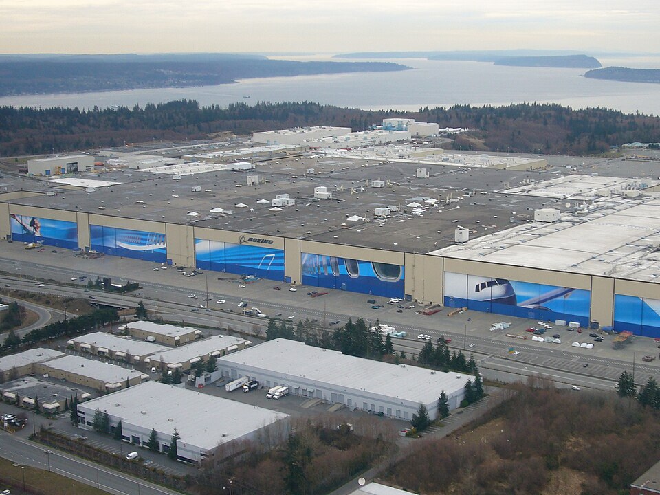 Aerial view of the Boeing Everett Plant complex, showing large aircraft-production buildings and surrounding factory infrastructure.
