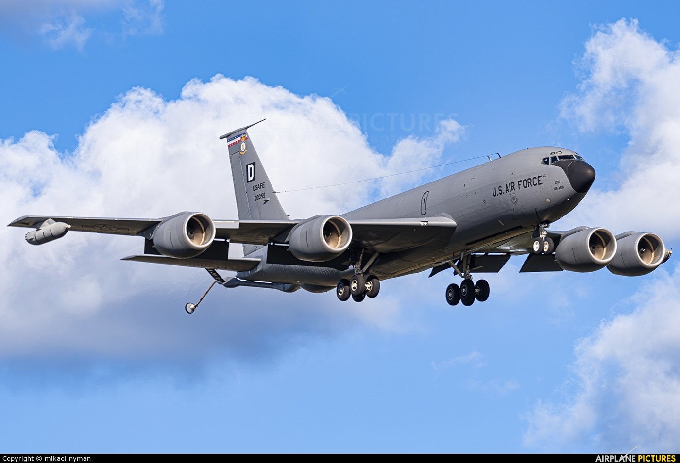 KC-135 Stratotanker flying with refueling boom extended below the tail.