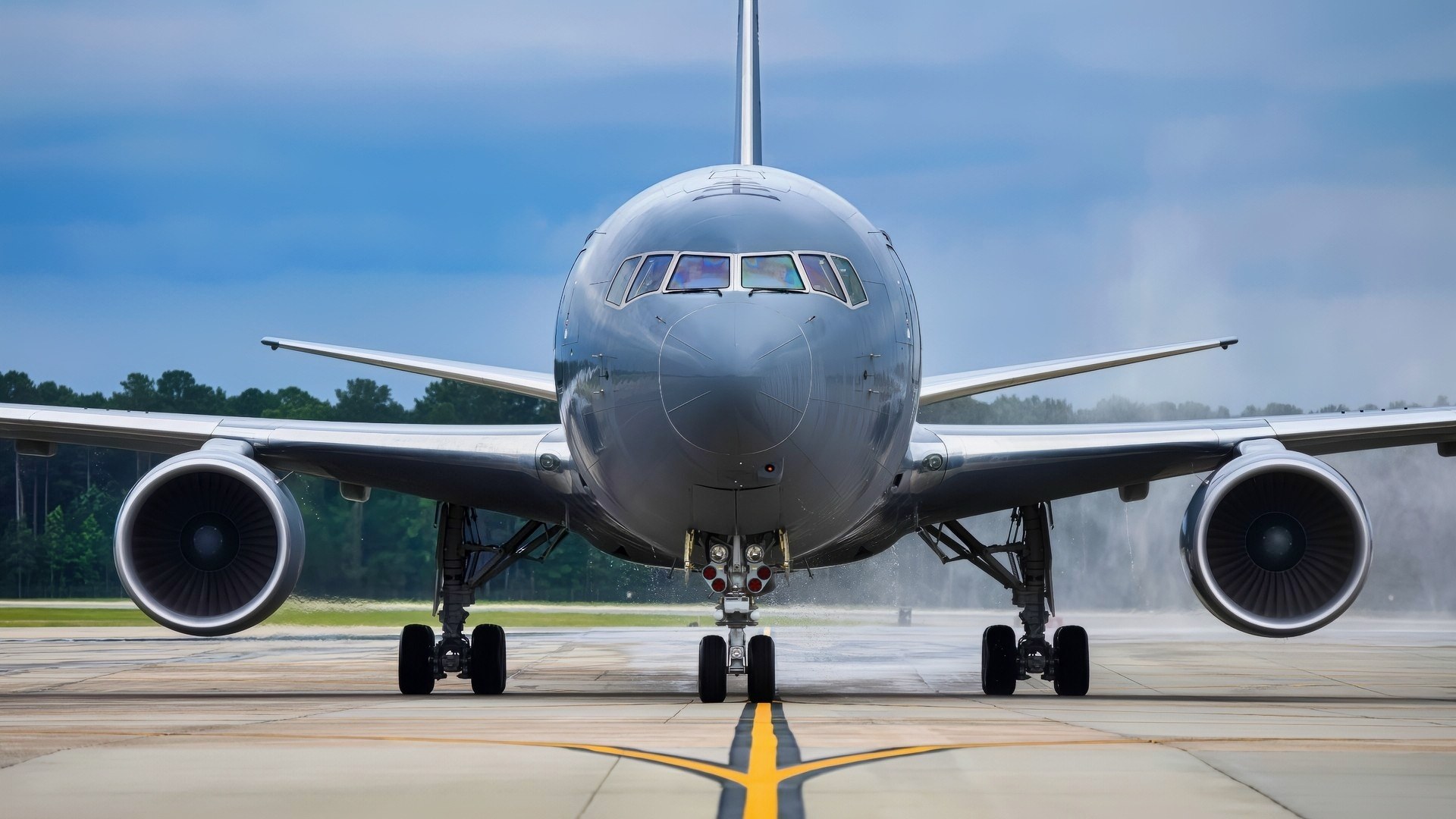 KC-46 Pegasus facing the camera on a wet runway.