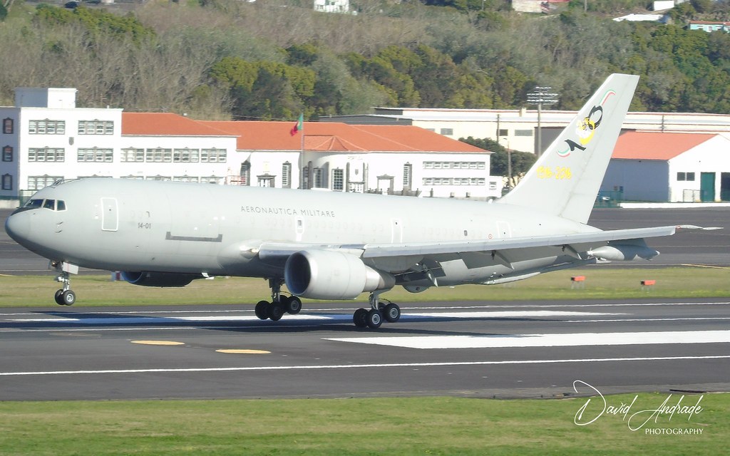 Italian KC-767A 14-01 rolling on a runway with buildings behind it.