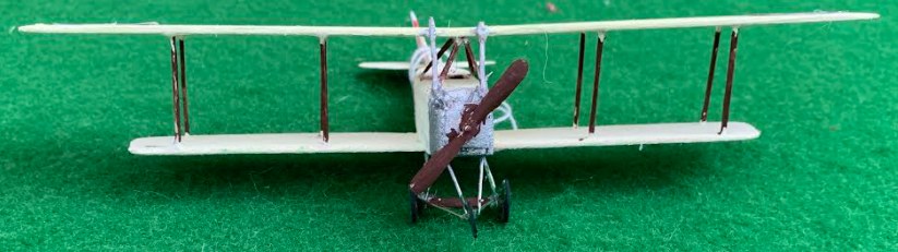 Front view of a Boeing Model EA scale model on a green surface.