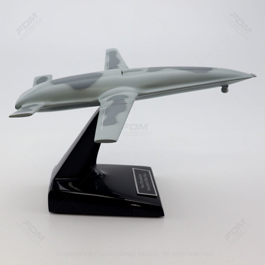 Small model of a Boeing MQ-25 Stingray mounted on a black display stand.
