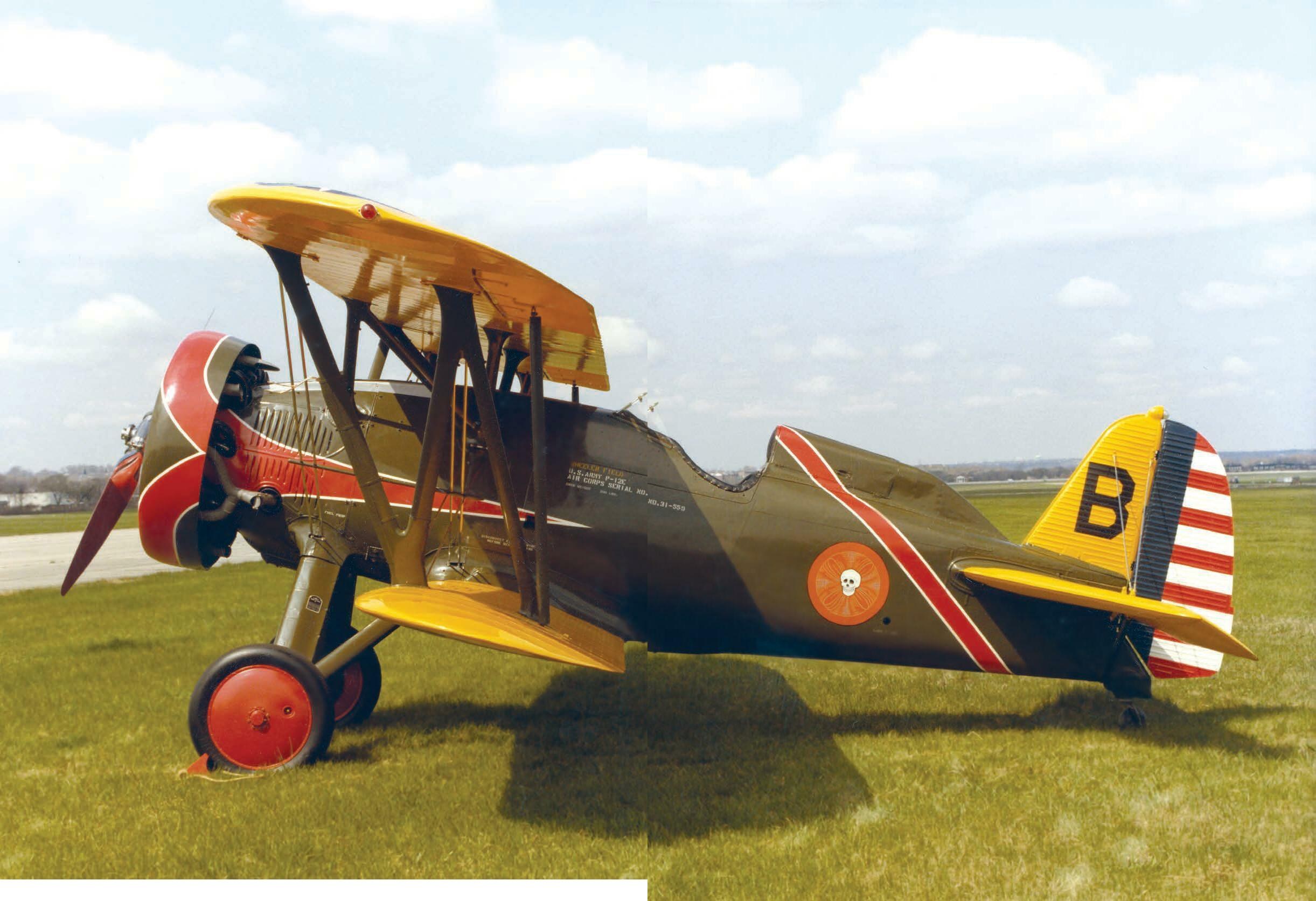 Boeing P-12 biplane marked B in a color side view on grass.