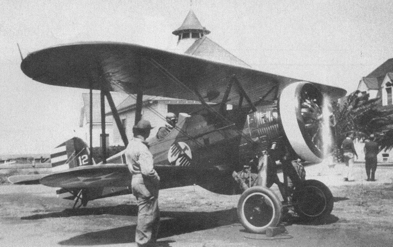 Black-and-white printed view of Boeing P-12 biplanes with people nearby.