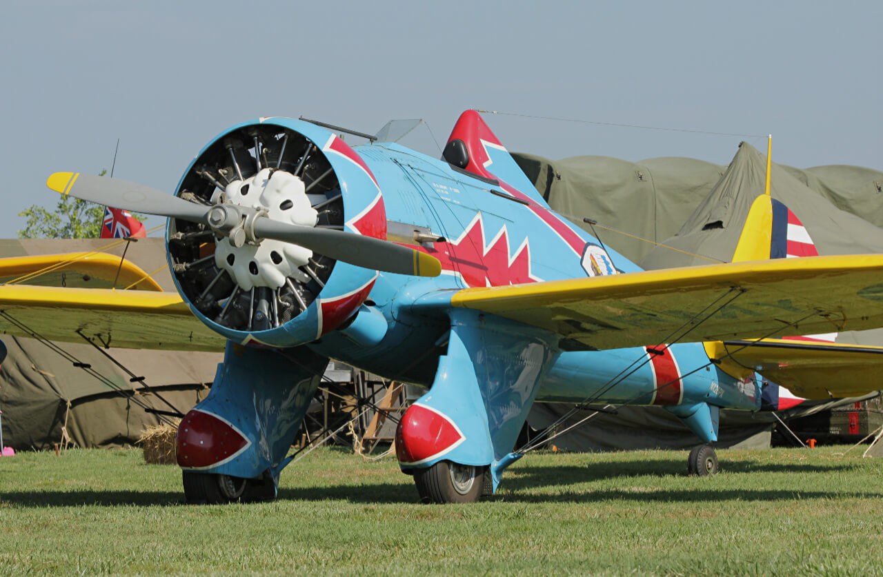 Blue Boeing P-26 Peashooter close view of radial engine and yellow wings.