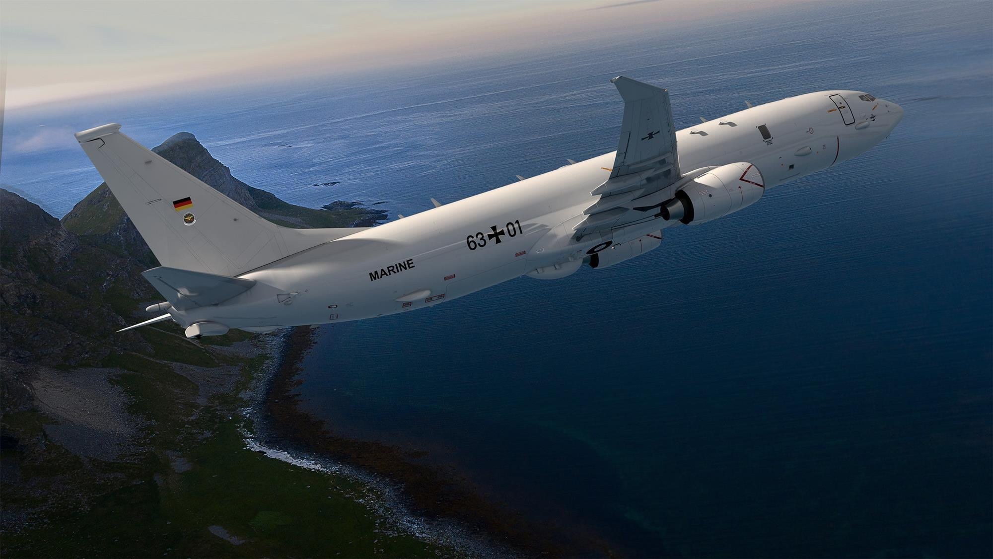 German Navy P-8 Poseidon 63+01 banking above a rocky coastline.