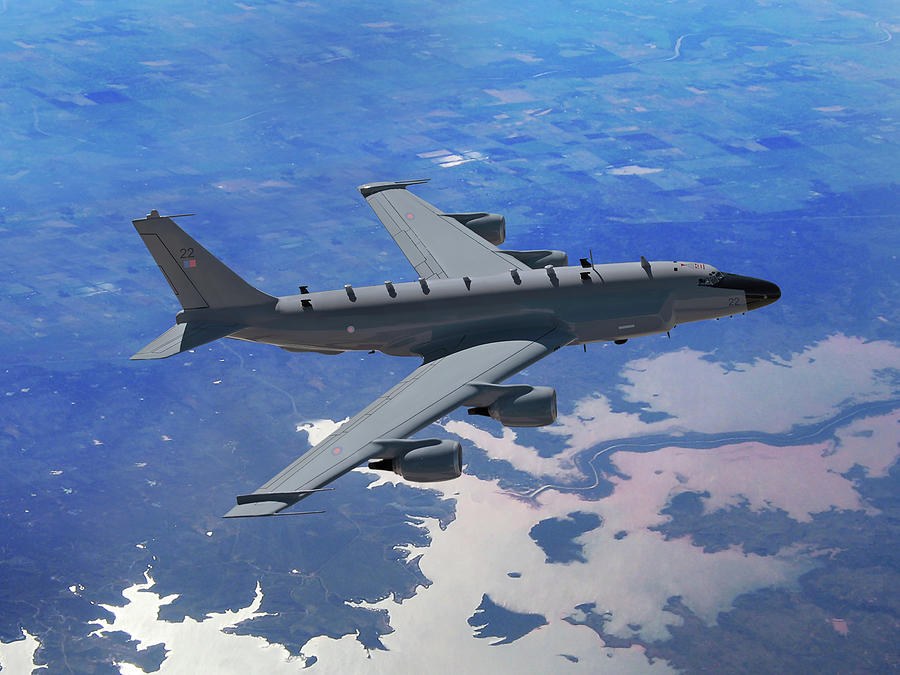 Royal Air Force RC-135W Rivet Joint aircraft 22 flying above lakes and farmland.