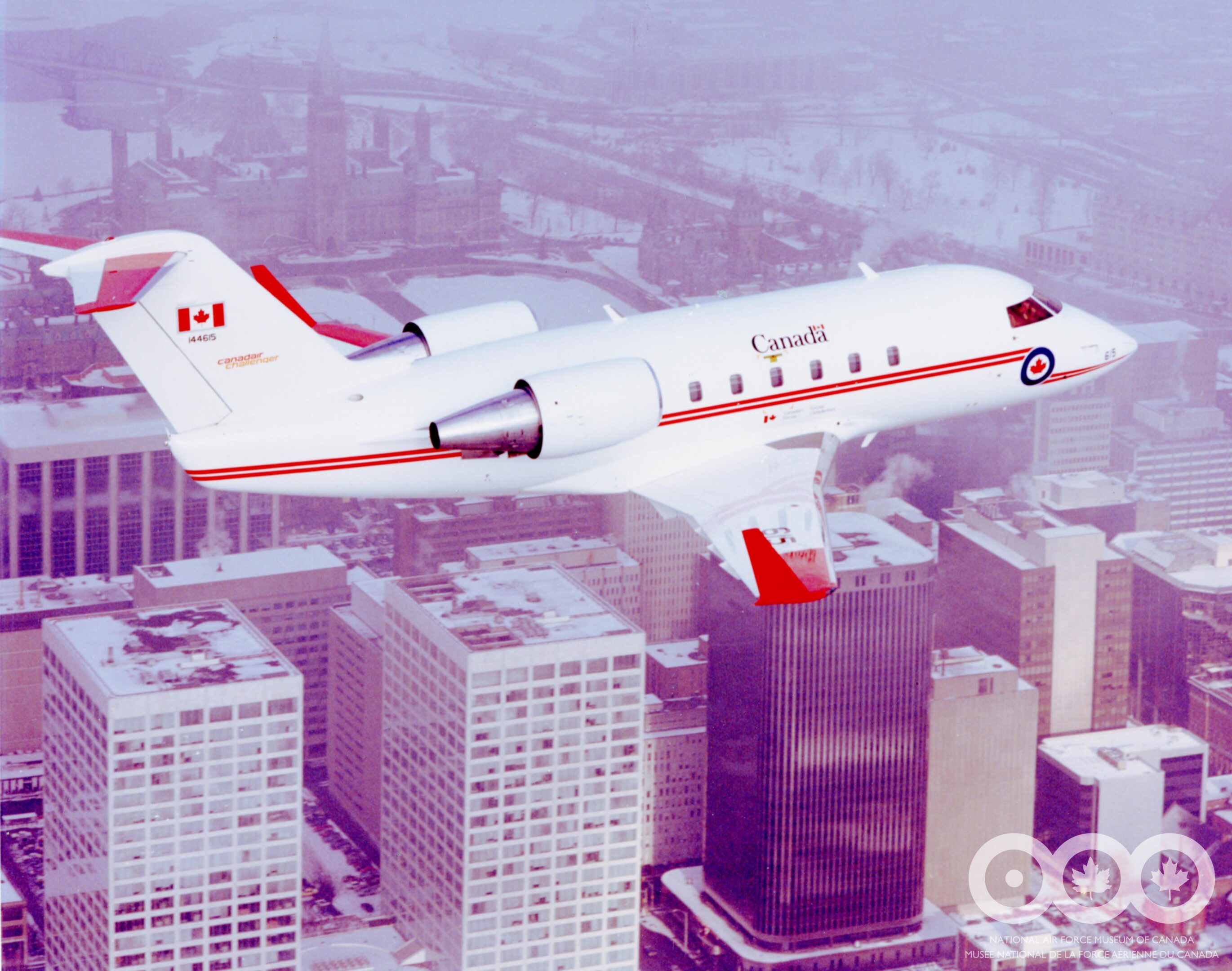 Canadair Challenger 14465 side profile over an Ottawa city background.