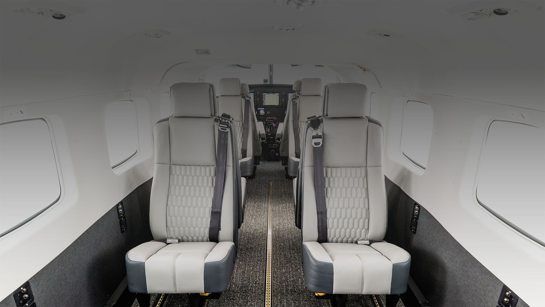 Light-colored Cessna Grand Caravan EX passenger cabin with aisle seating