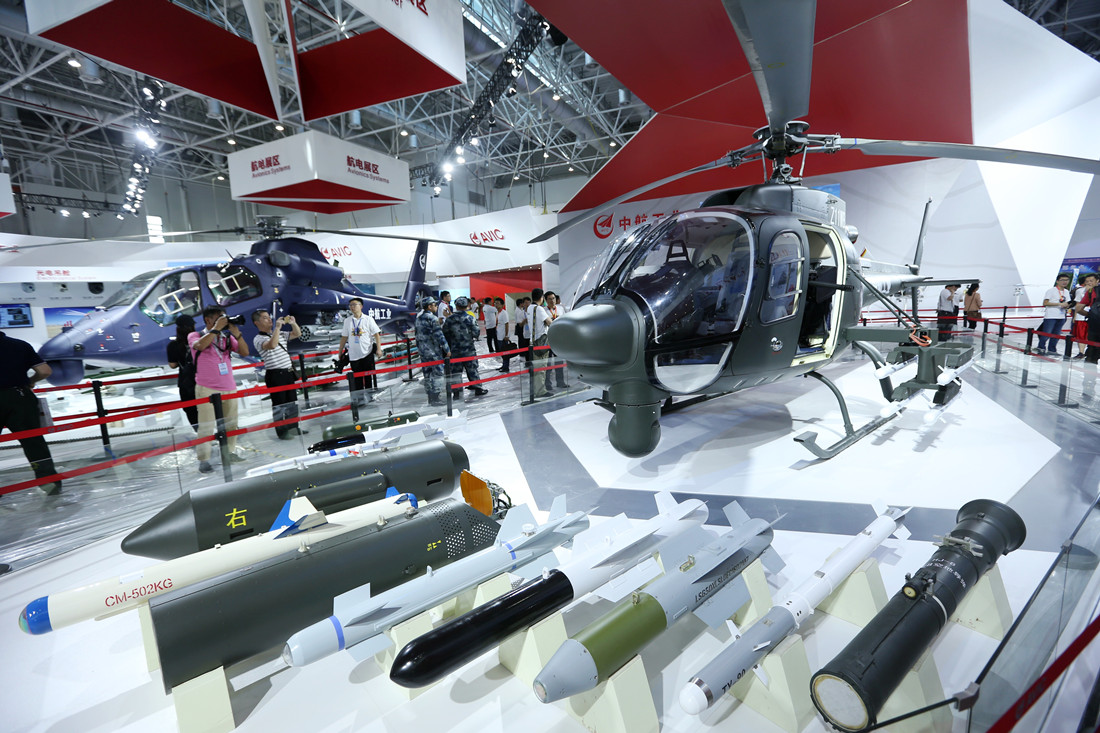 Close view of the Changhe Z-11WB cabin door and mounted weapon system.