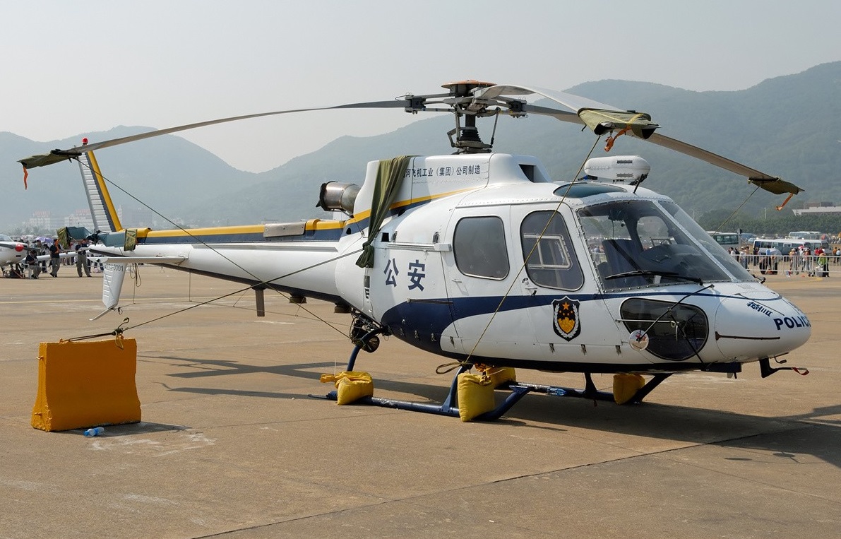 Changhe Z-11 police helicopter parked outdoors on a flight ramp.