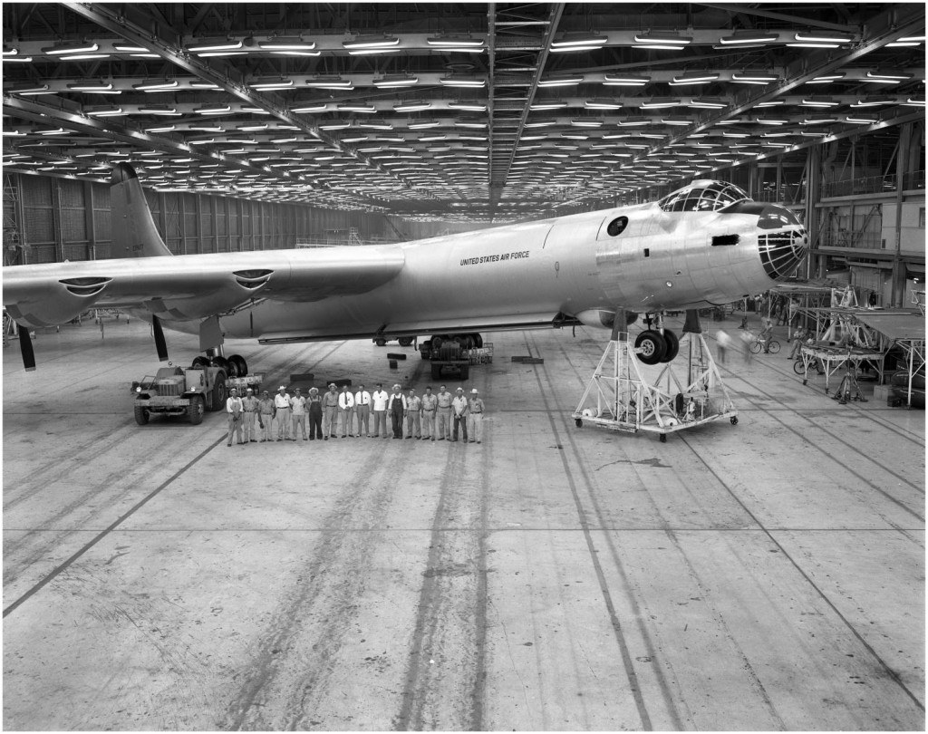 Convair B-36 Peacemaker inside a hangar with a line of people under the wing.