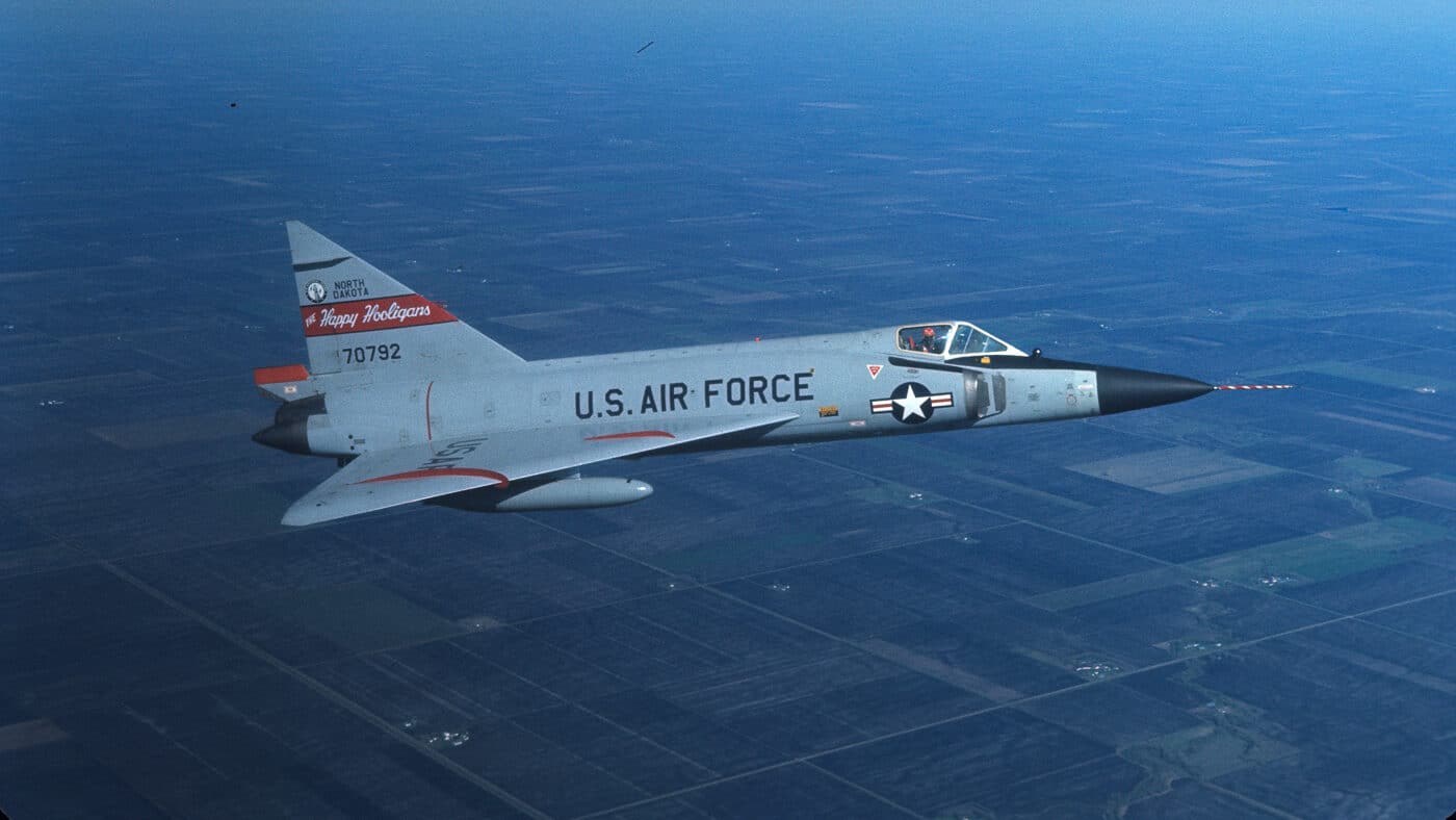 Convair F-102 Delta Dagger 70792 flying over farmland.